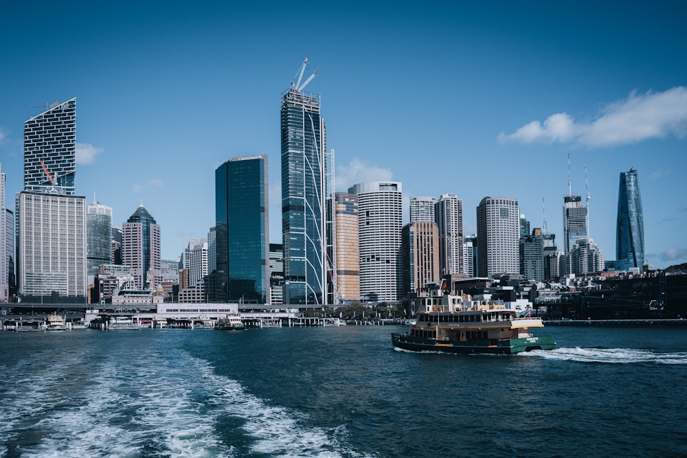 a boat in the water with a city in the background