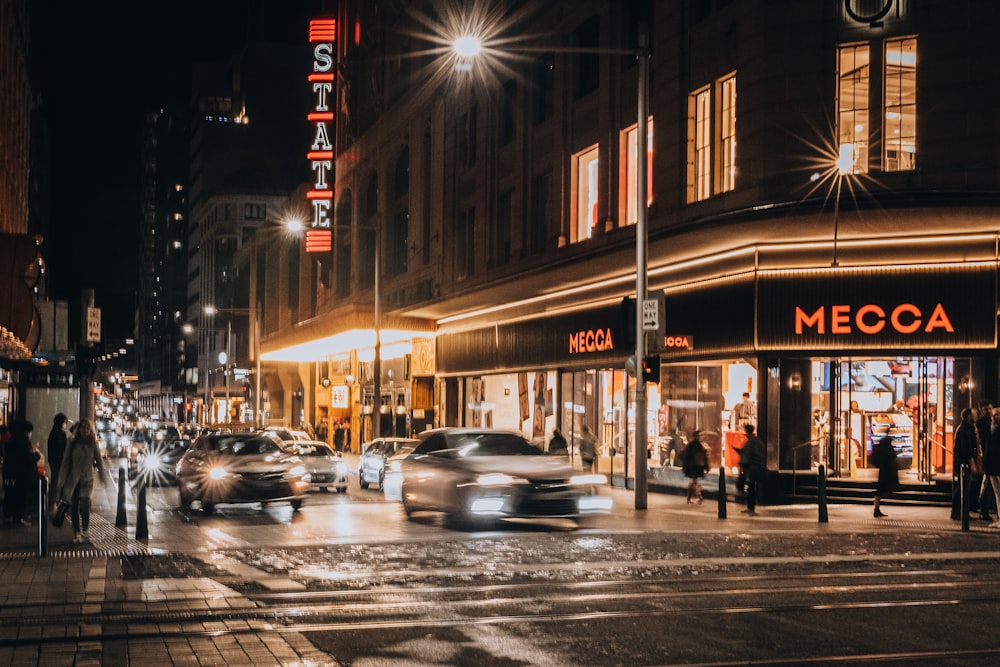 a street with cars and people on it with lights on the side