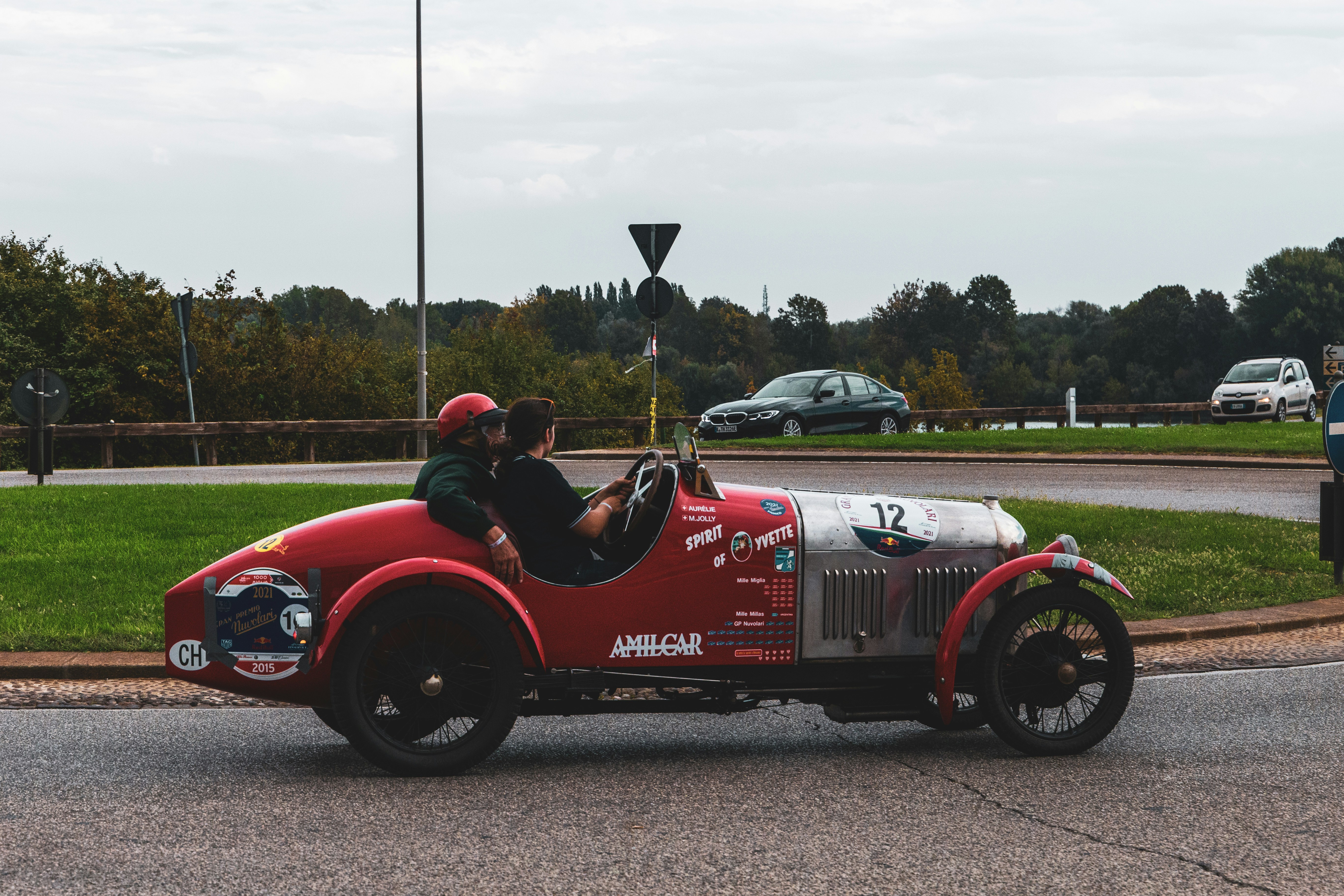a group of people in a red car on a road