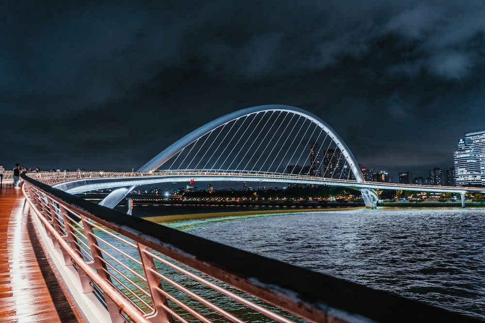 a bridge over water with a building in the background