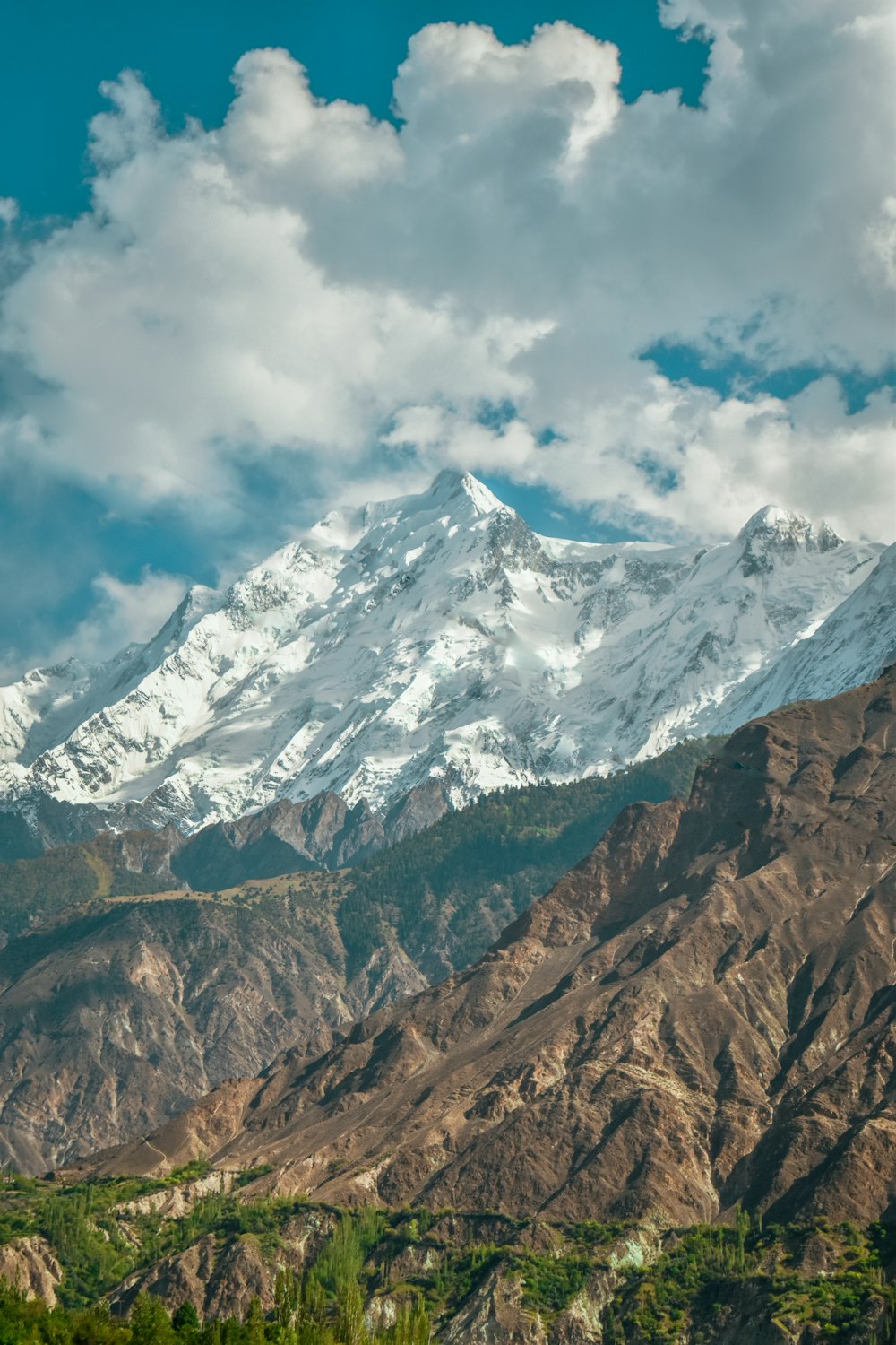 a mountain with clouds above it