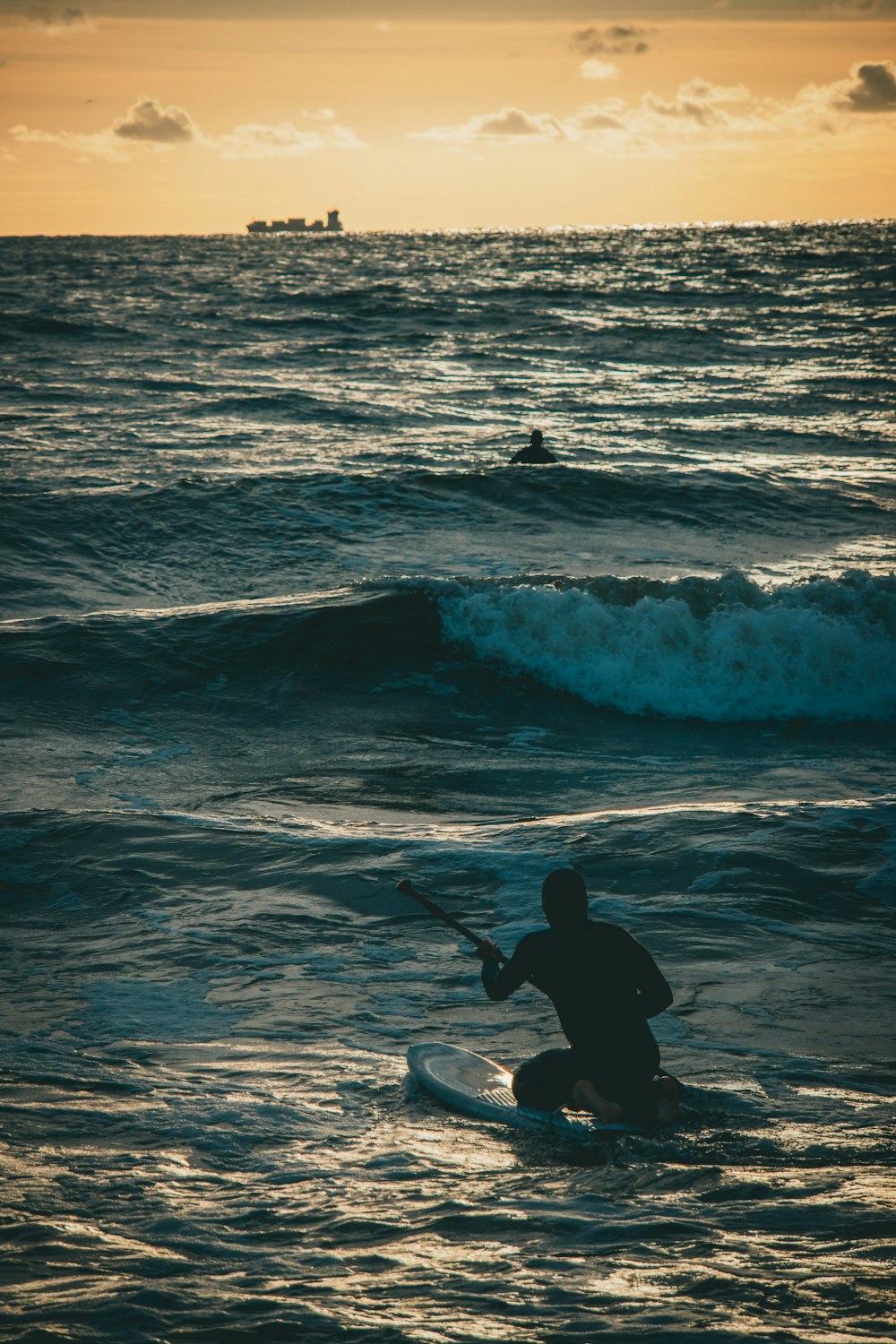 a man paddle boarding in the ocean