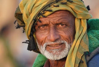 Portrait of Pesaj Berim, a dignified elderly man with a warm smile.