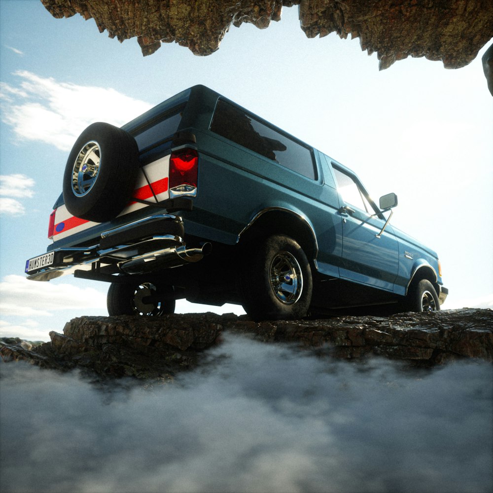 a blue truck on a rock