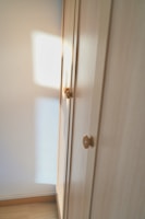 A beautifully aged wooden dresser with brass handles, bathed in soft natural light.