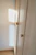 An elegant wooden wardrobe design complemented by soft lighting in a spacious bungalow bedroom.