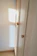 A sleek two-door wardrobe in a cozy bedroom setting with warm lighting.