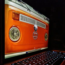 A friendly customer using a laptop to get an instant van valuation on a clean, modern website.