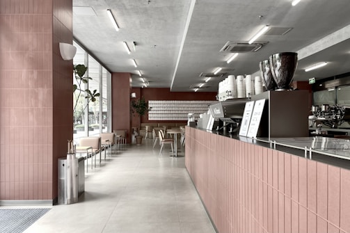 a large kitchen with red tile