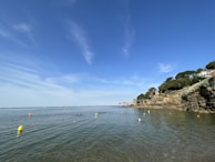 Early morning ocean view with swim route markers floating on the water