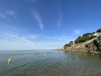 An aerial view of the open water route marked with buoys showing the swimmers’ path under a blue sky.