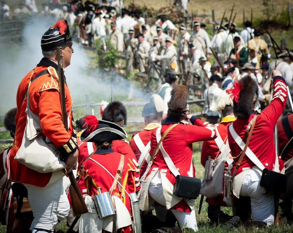 a group of people in red and white uniforms holding rifles