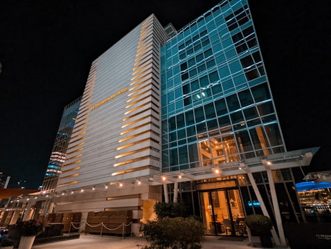 Exterior shot of a modern building with well-lit signage at dusk