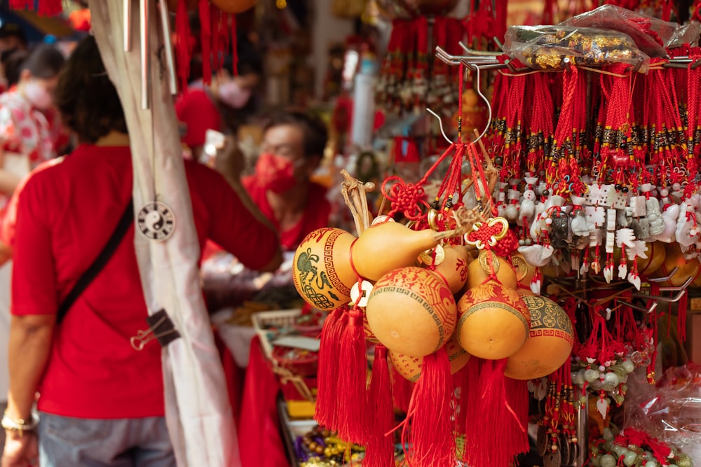 a person standing next to a display of colorful lanterns