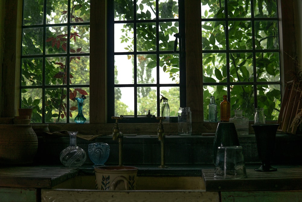 a window with many vases and dishes in it