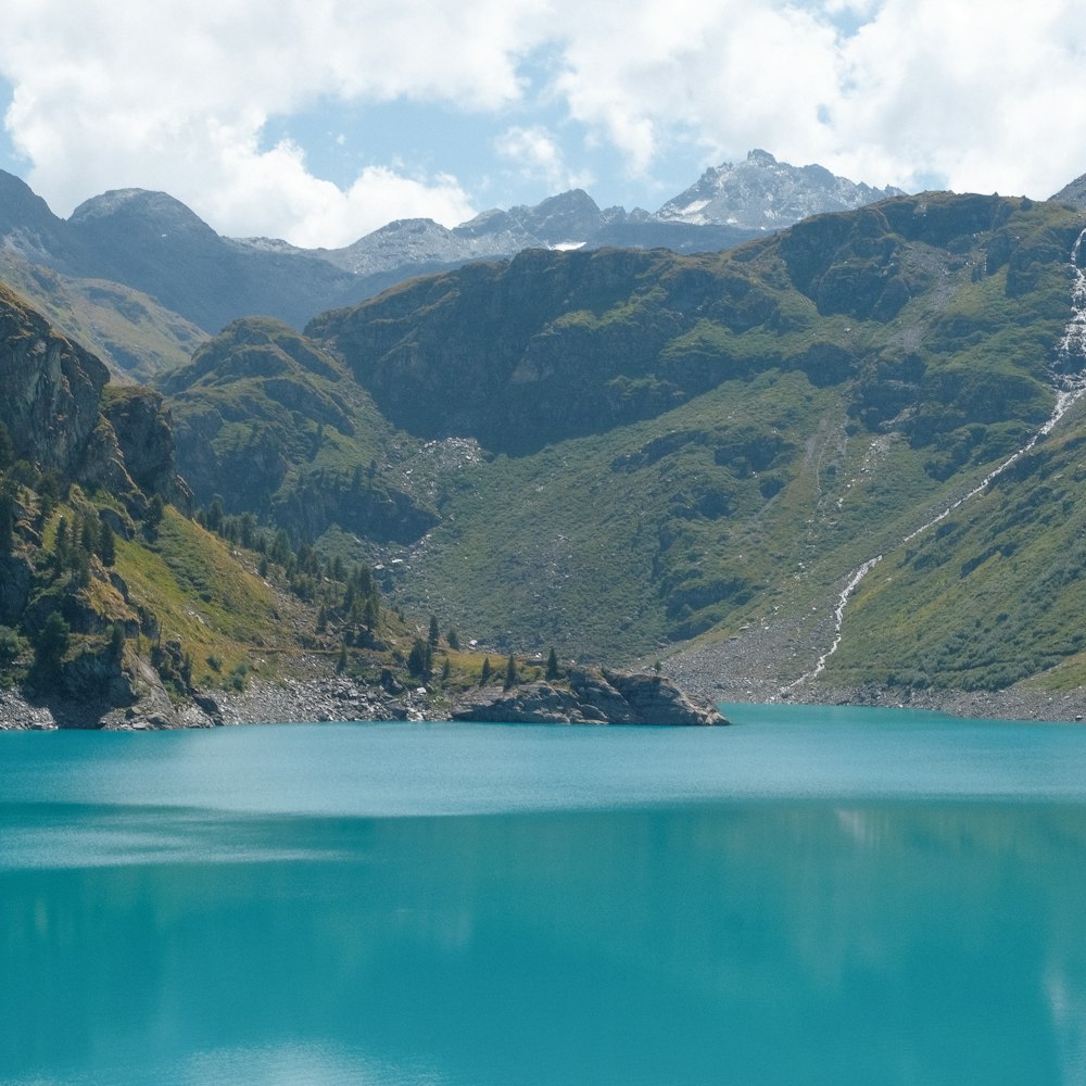 a body of water with mountains in the back