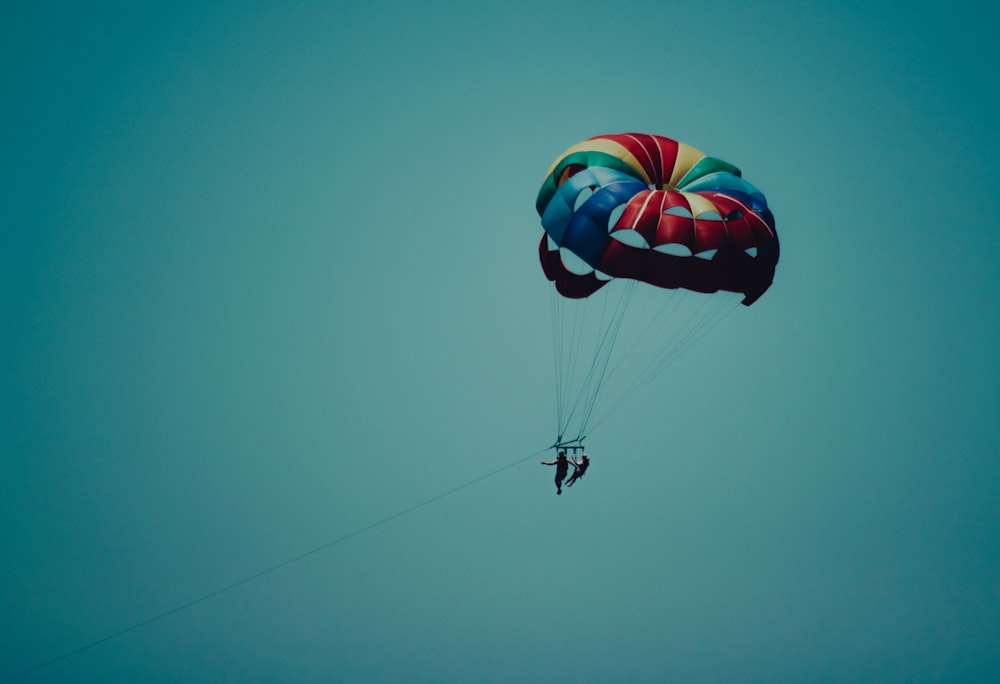 a person in the air with a parachute
