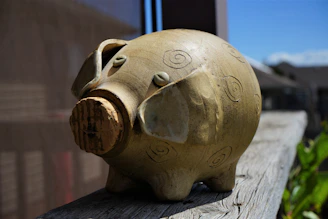 Close-up of a velvet-finished handcrafted piggy bank from Tulancingo with intricate details.