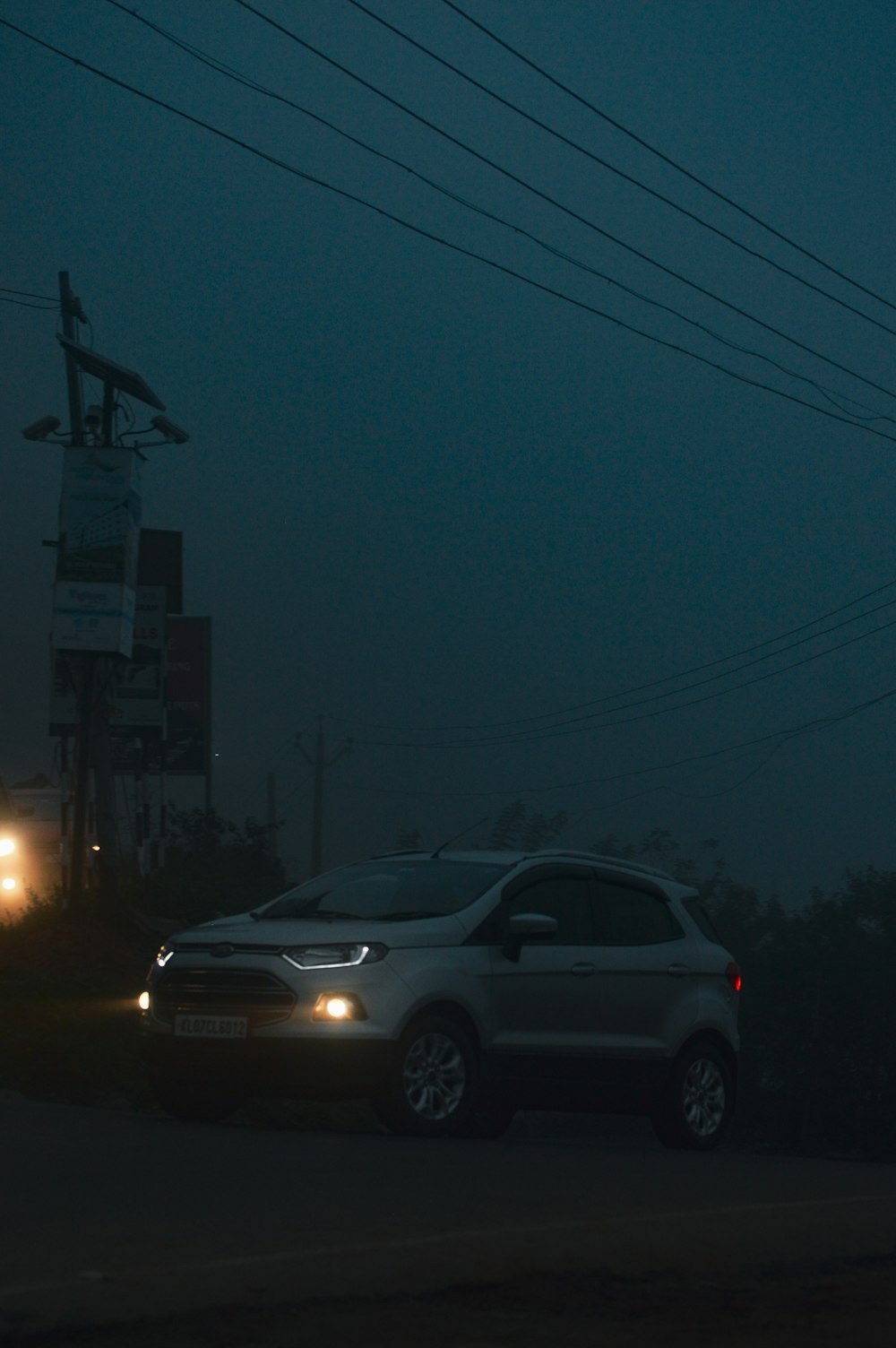 a car parked on the side of the road at night