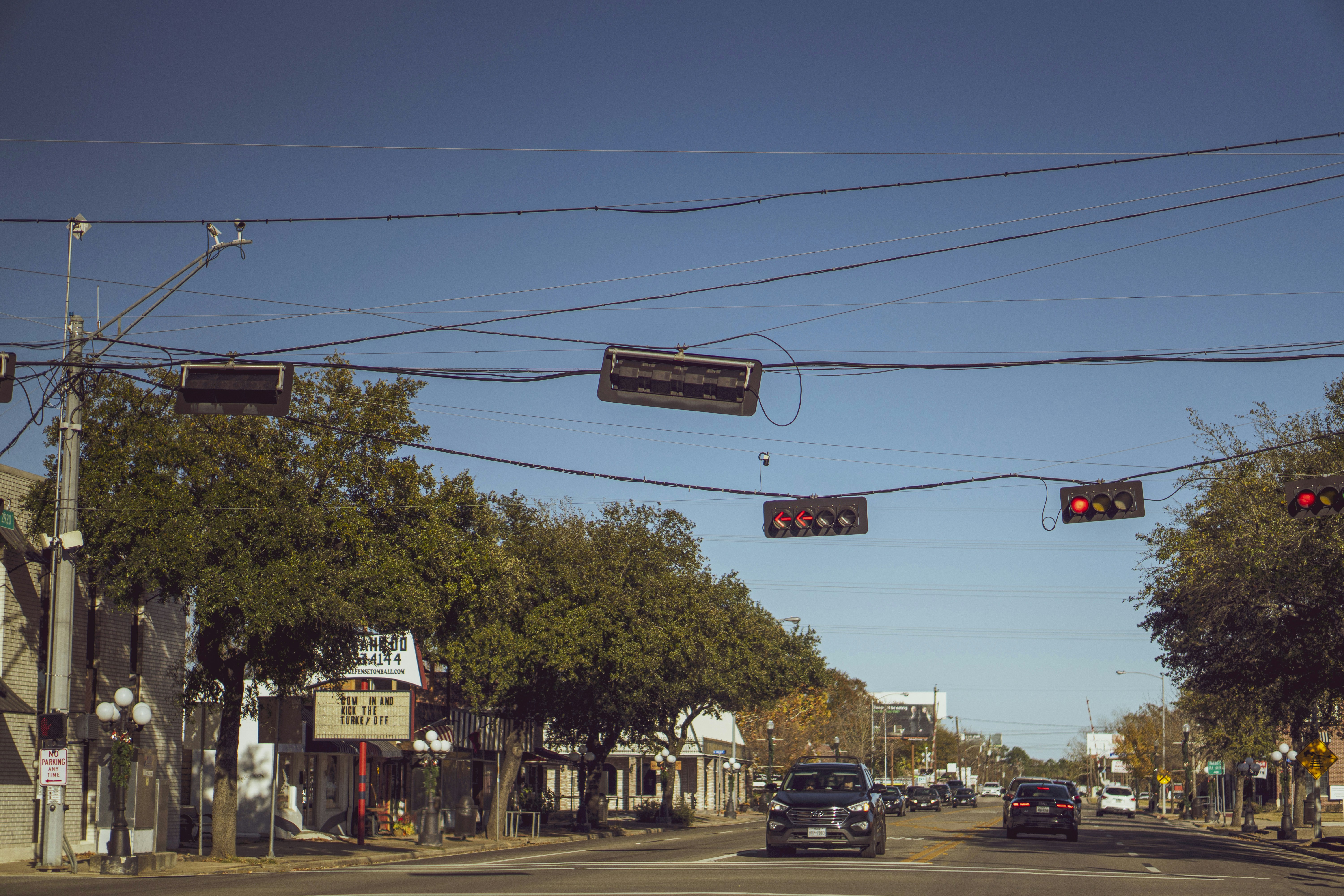 a street sign hangs over a busy street