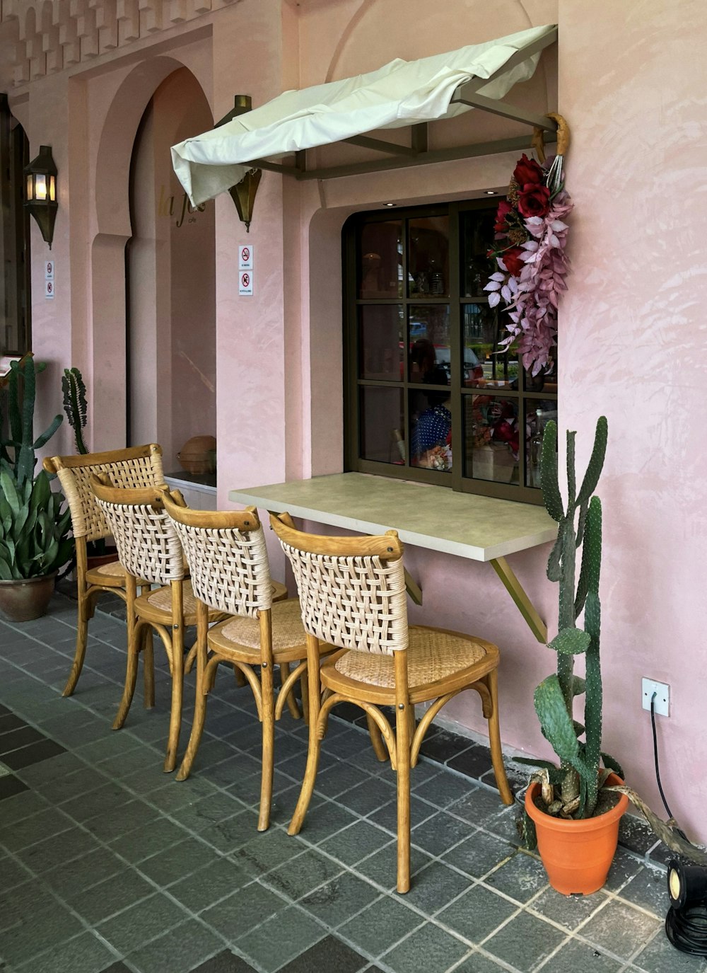 a table with chairs and a plant