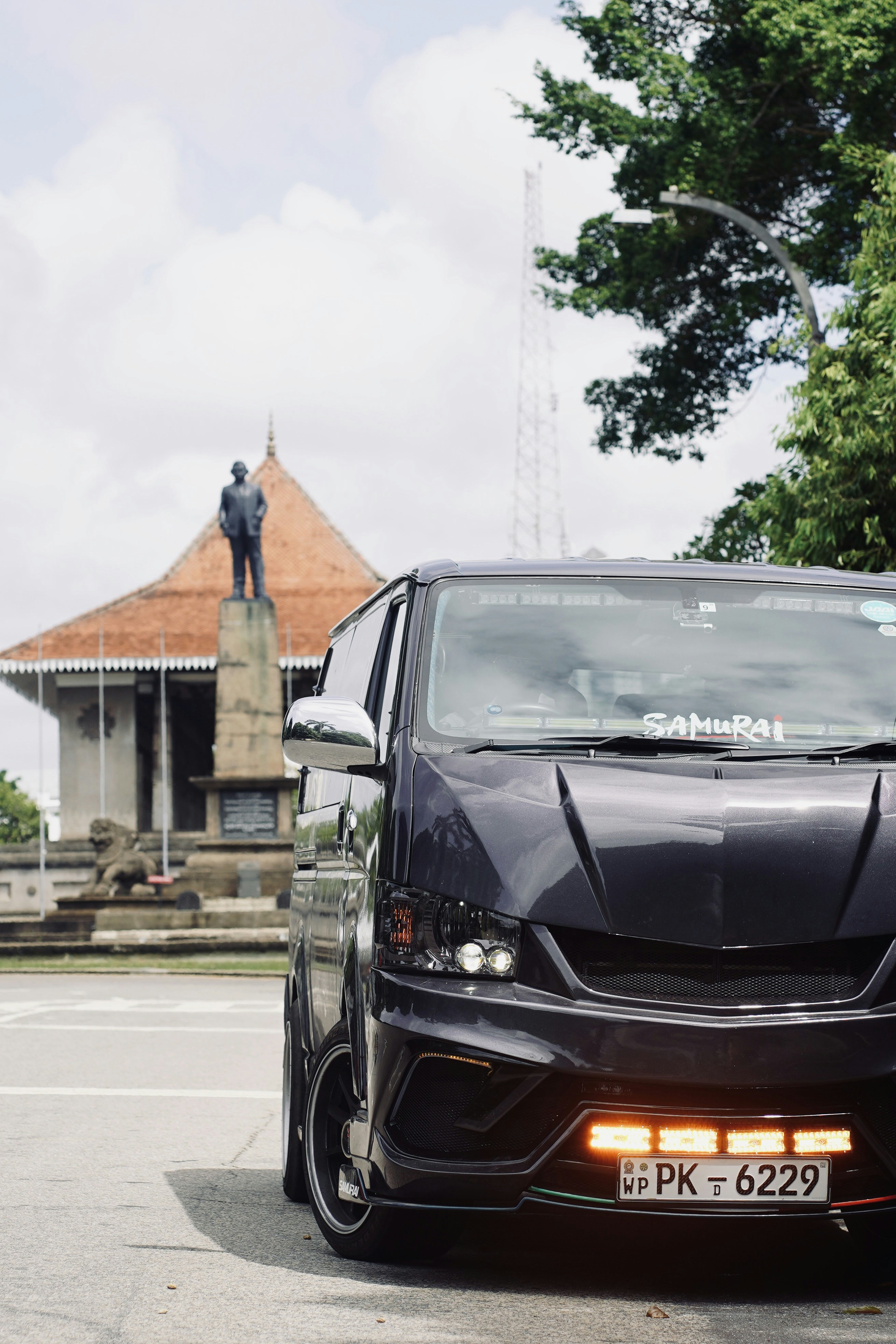A black car parked in front of a building photo – Free Samurai Image on ...