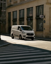 a white car parked on the side of a street