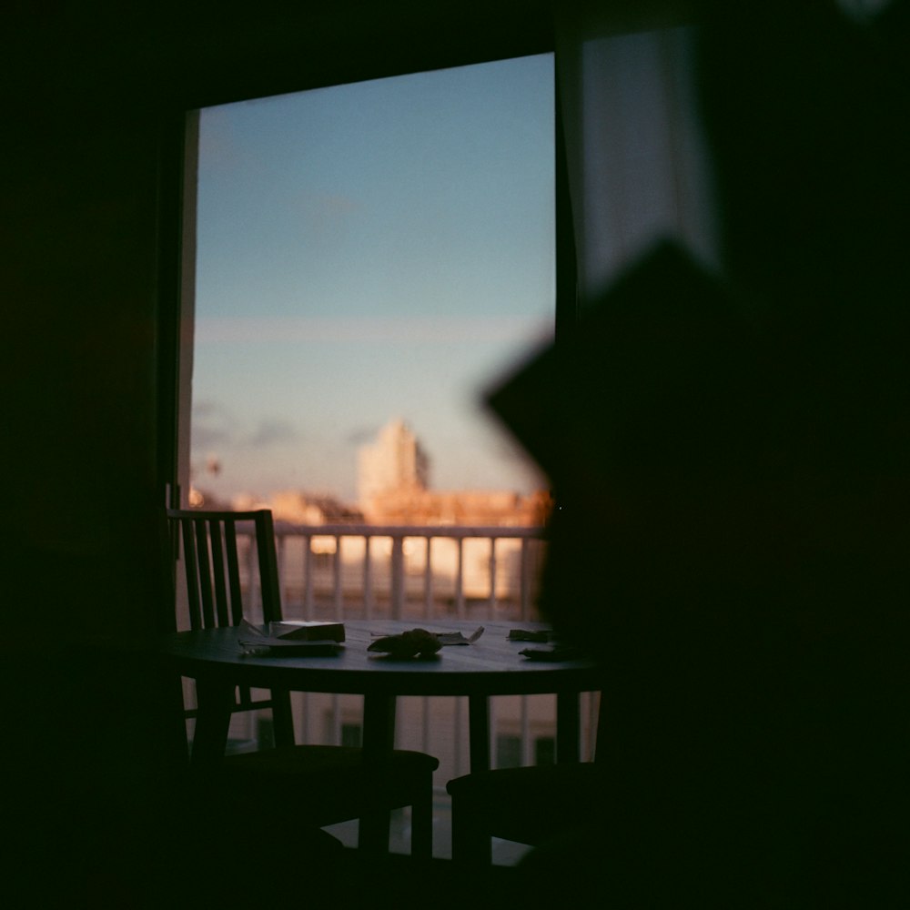 a table with a plate of food in front of a window