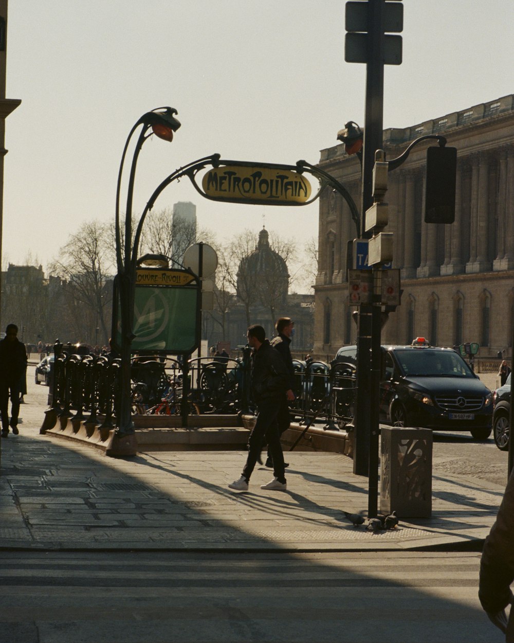 a group of people walking on a sidewalk