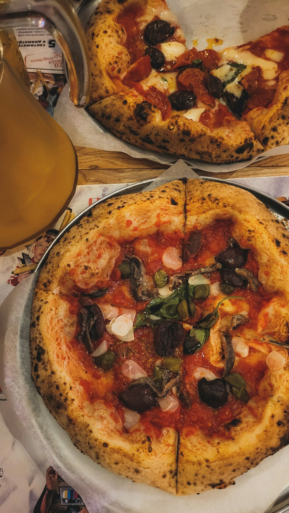 a couple of pizzas sit on a table