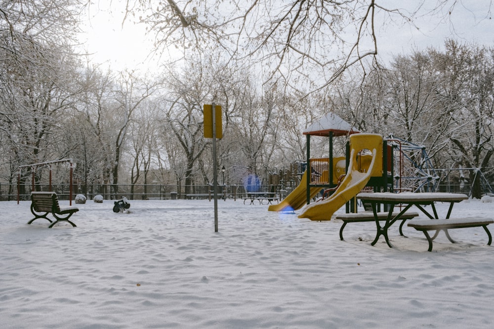 a playground with benches and a slide