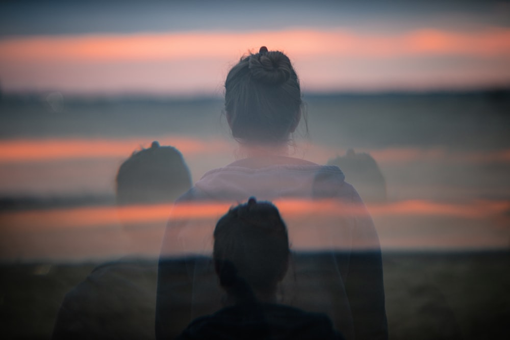 a group of people looking at the sunset