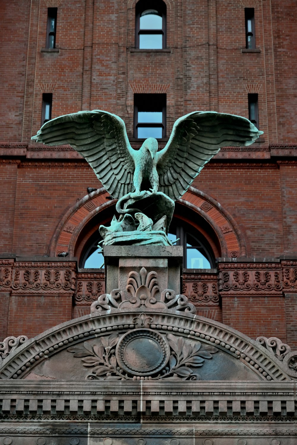a statue of a bird on a building