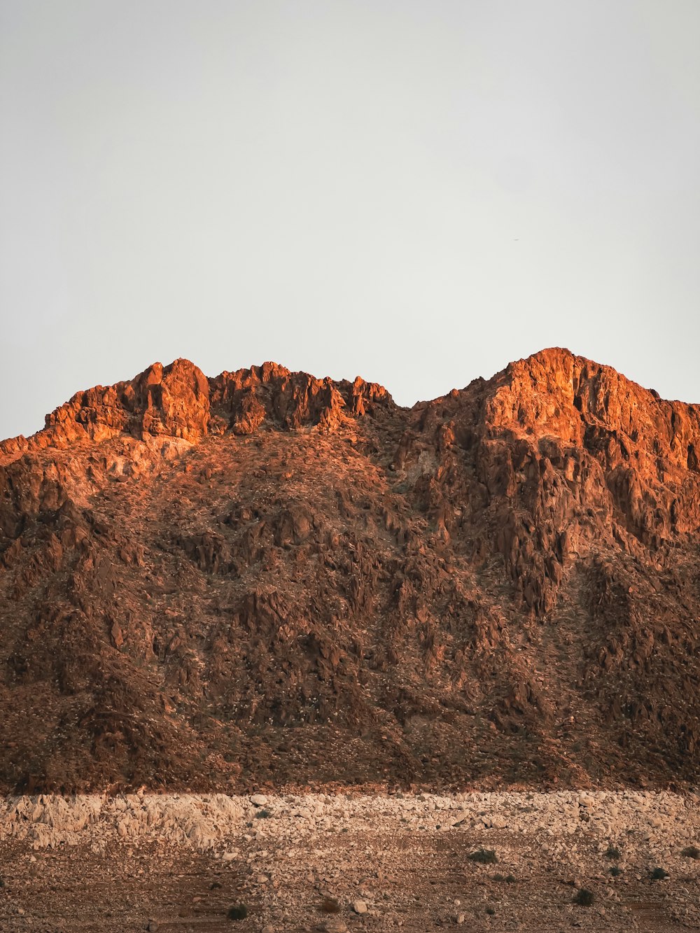 a rocky mountain with a dirt road