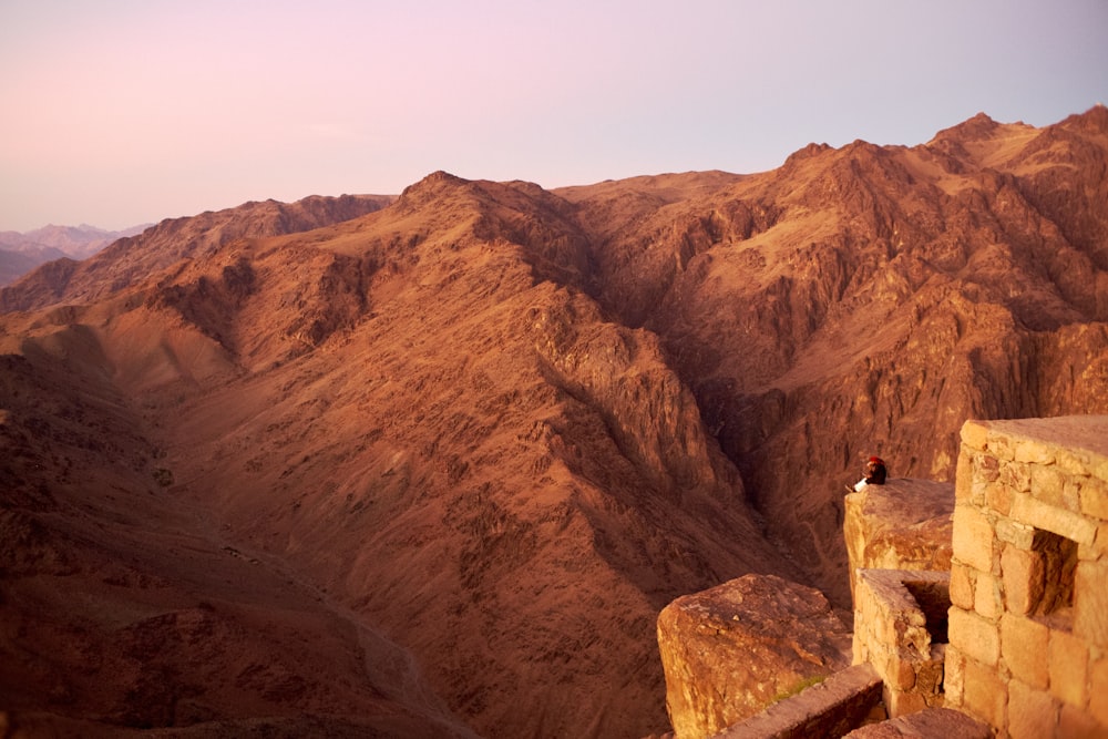 a person standing on a rock wall