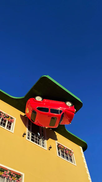 a red car on a yellow building