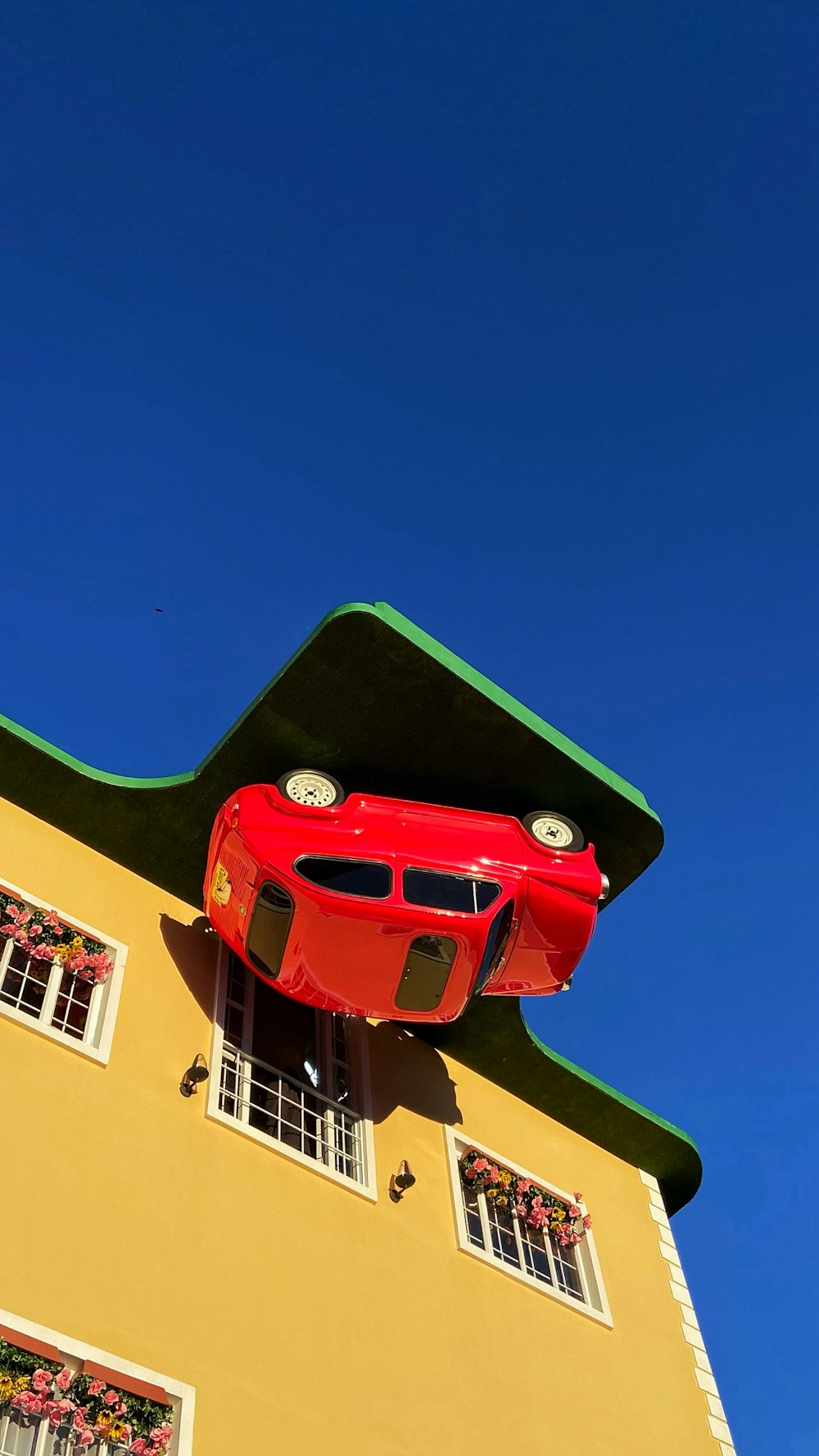 a red car on a yellow building