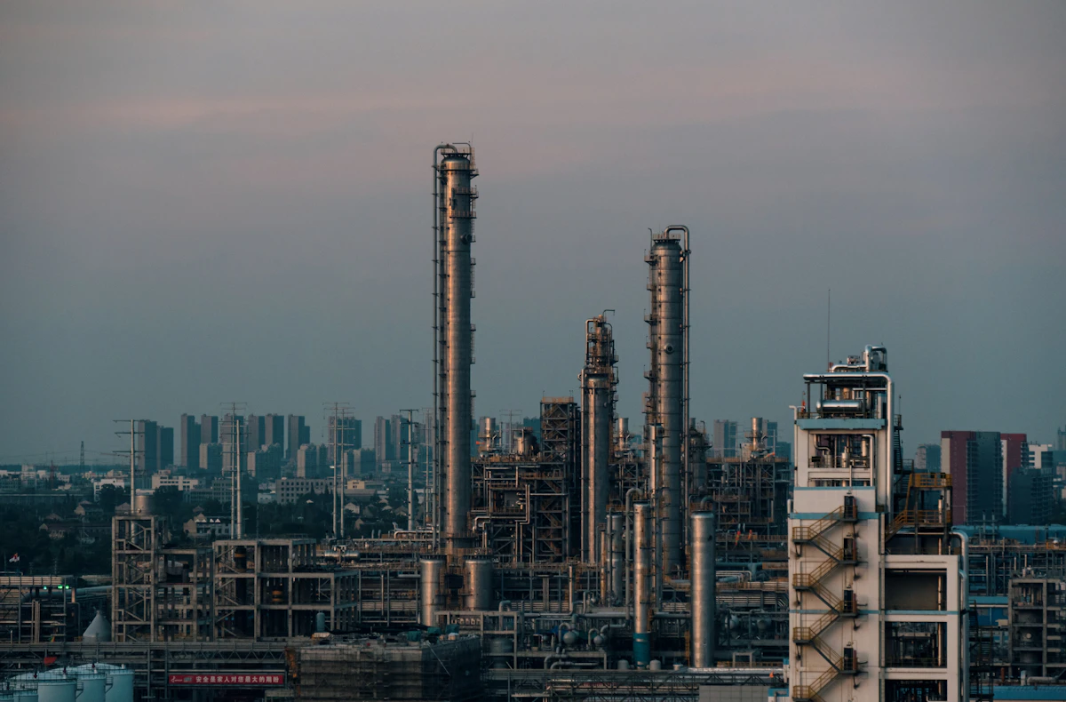 Rows of chemical storage drums and containers in an industrial warehouse facility for solvent distribution and supply chain operations