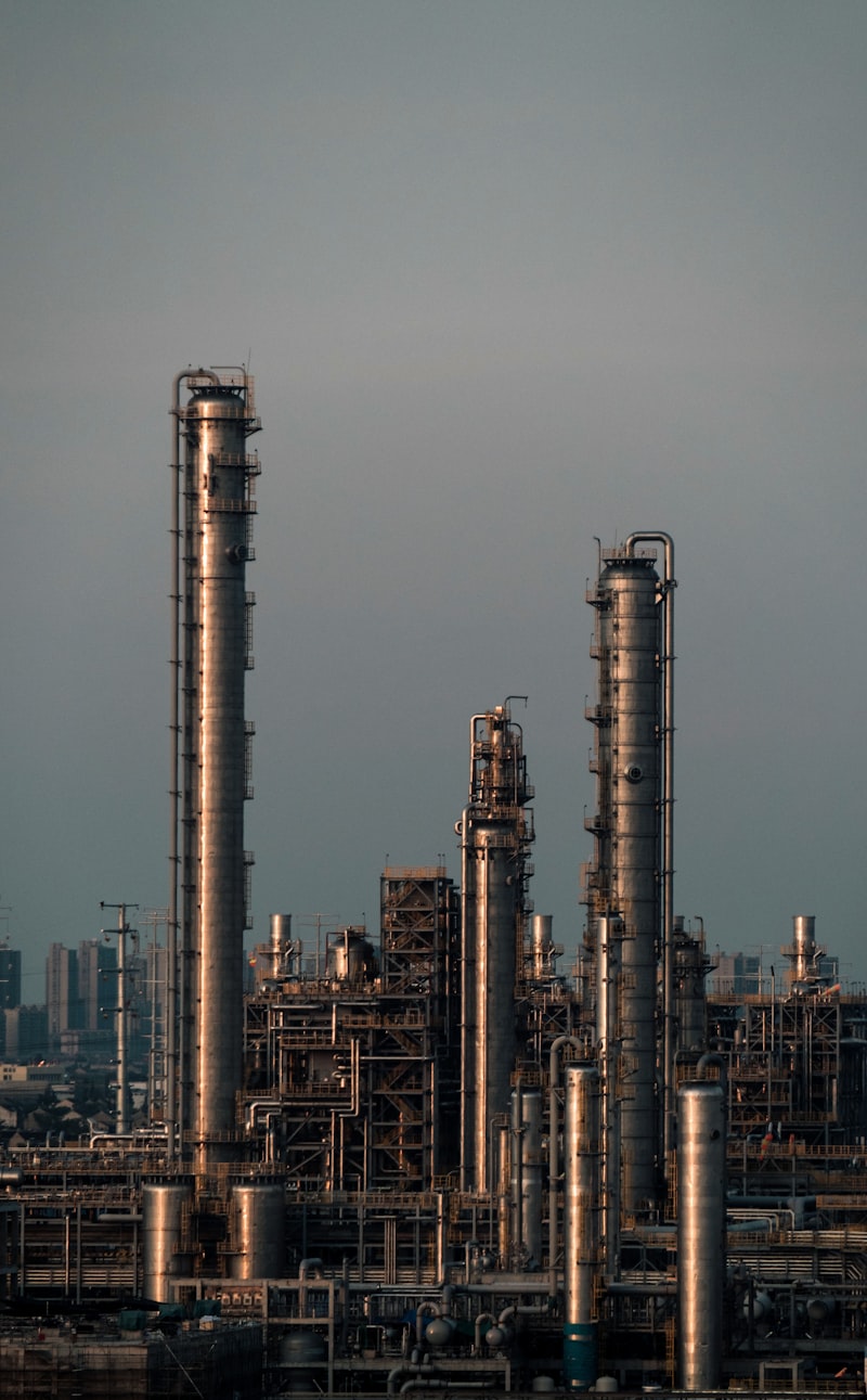 An oil refinery with distillation columns at dusk