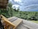 Guest enjoying a wooden deck overlooking the vibrant Amazon forest.