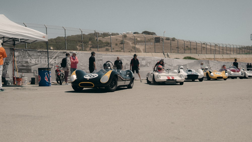 a group of people around a race car