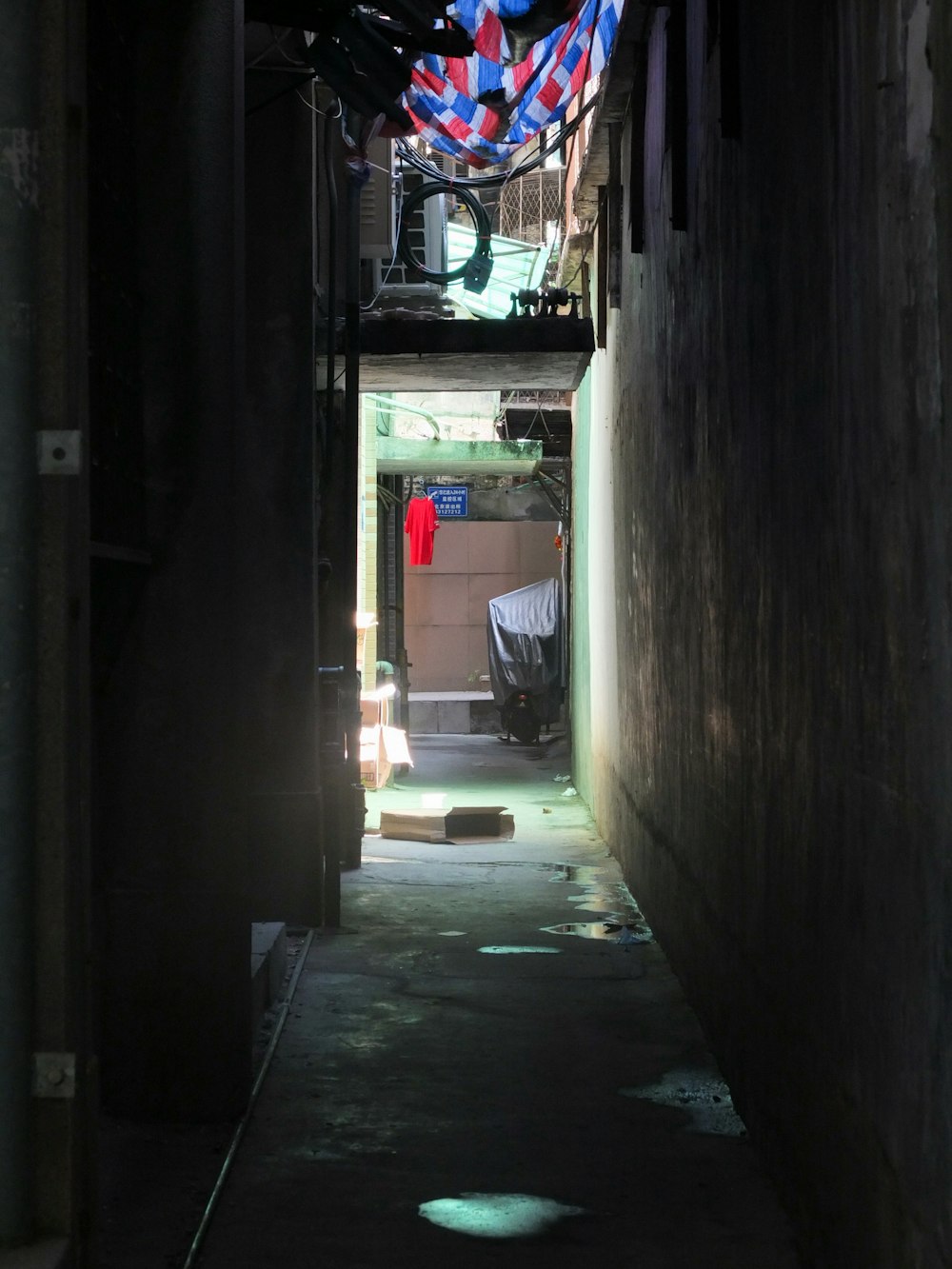 a narrow alley way with a car parked in it