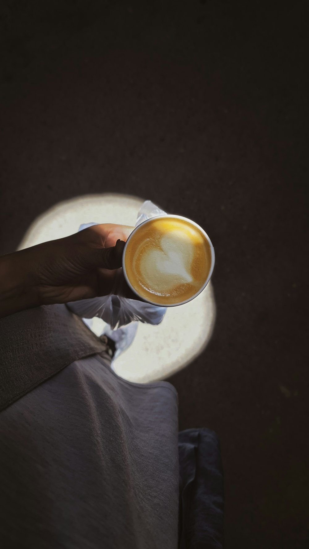 a person holding a cup of coffee