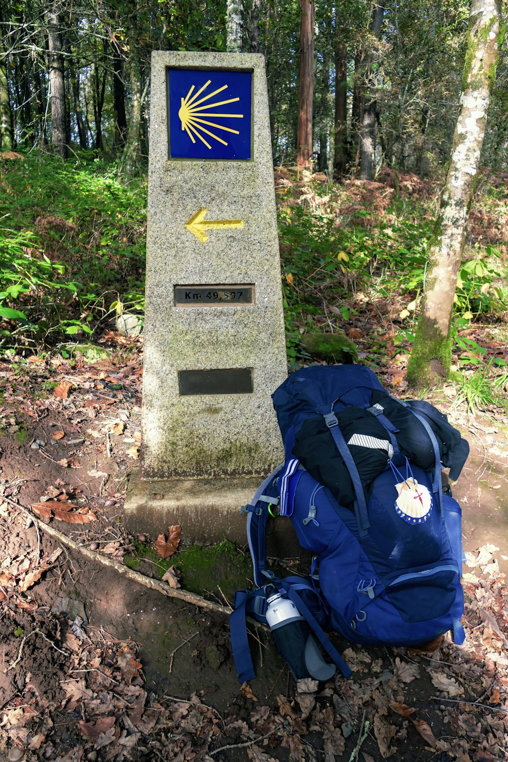 a backpack next to a stone pillar