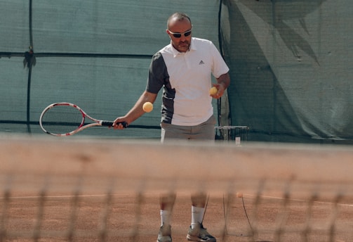 a man hitting a ball with a tennis racket