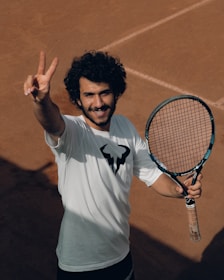 a man holding a tennis racket