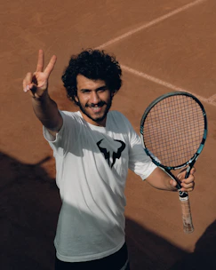 a man holding a tennis racket