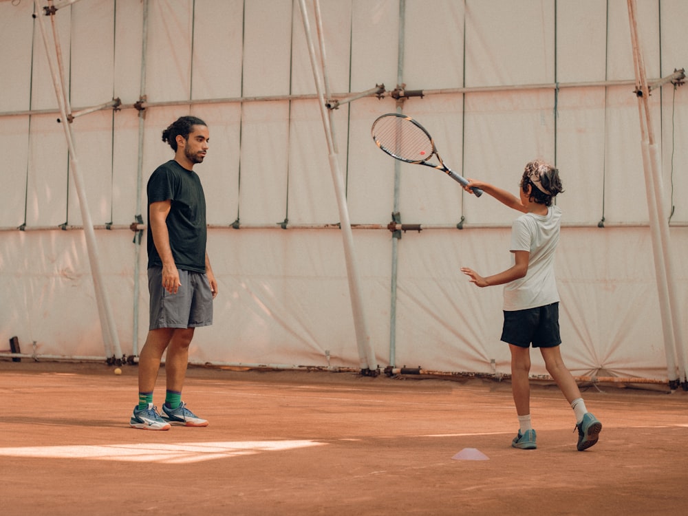 a couple of men playing tennis