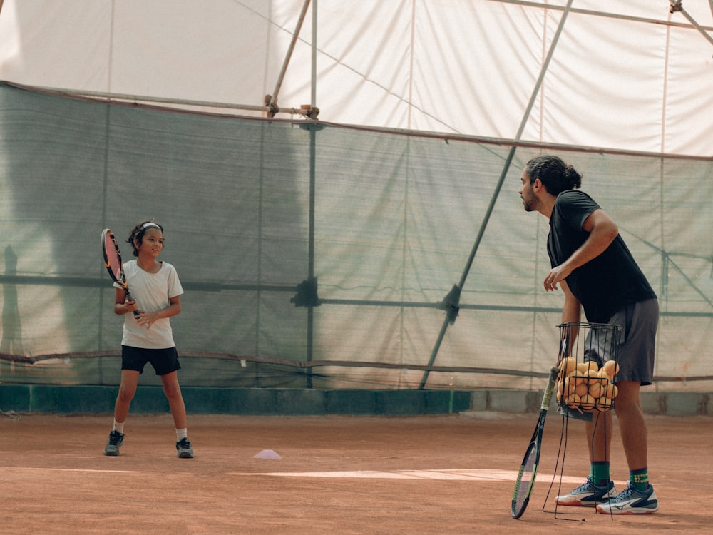 a couple of people play tennis