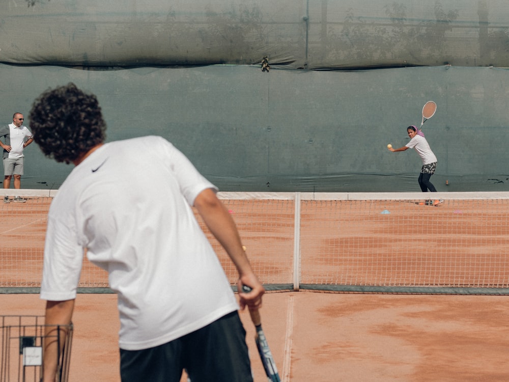 a man hitting a ball with a tennis racket